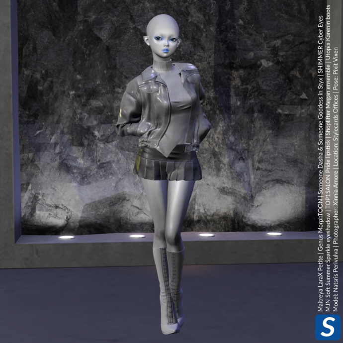 Natsris Perivulva is a grey-skinned alien from Mars, who lacks any hair, but has slightly pointy ears. She is wearing an asymmetric sweater, leather jacket, pleated skirt, and high-heeled boots, all in grey to match her skin. She is standing in front of a grey rock face while standing on a grey concrete floor.