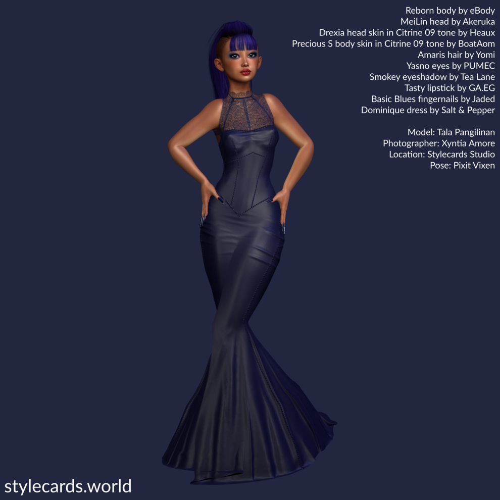Model Tala Pangilinan wear a dark blue floor-length leather dress adorned with lace at the top. She has a bright blue Mohawk haircut with bangs covering her forehead and she is posed in front of a dark blue backdrop.