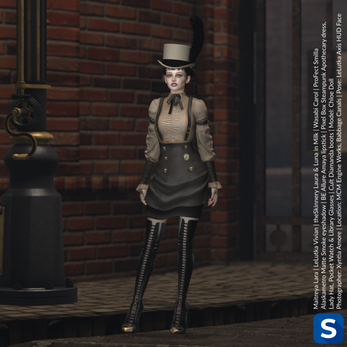 A photo of Chloe Doll in a steampunk inspired outfit in beige and brown with brass accents. Her high-heeled lace-up boots reach up to her thighs and have brass tips at the toes. Her glasses have brass frames and she is wearing a beige top hat with a large feather plume. She is standing in front of a brick wall near an iron gate and a gas street lamp.