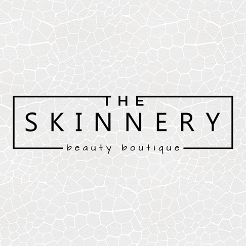 The logo for The Skinnery is black text in front of a pale beige paper-like texture.