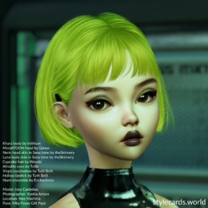 A headshot of new model Inez Cardeñas while she's wearing short, neon green hair from Wasabi, and makeup from Tutti Belli. She is standing in front of a rack of computers which has been blurred by depth-of-field.