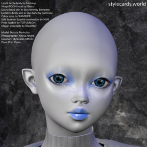 In this nearly black-and-white image, grey-skinned Natsris Perivulva of Mars wears a grey ensemble from Shoplifter while standing in front of a grey rock wall in the Stylecards Offices. She has purplish freckles, blue eyes, blue eyeshadow, and blue lipstick.