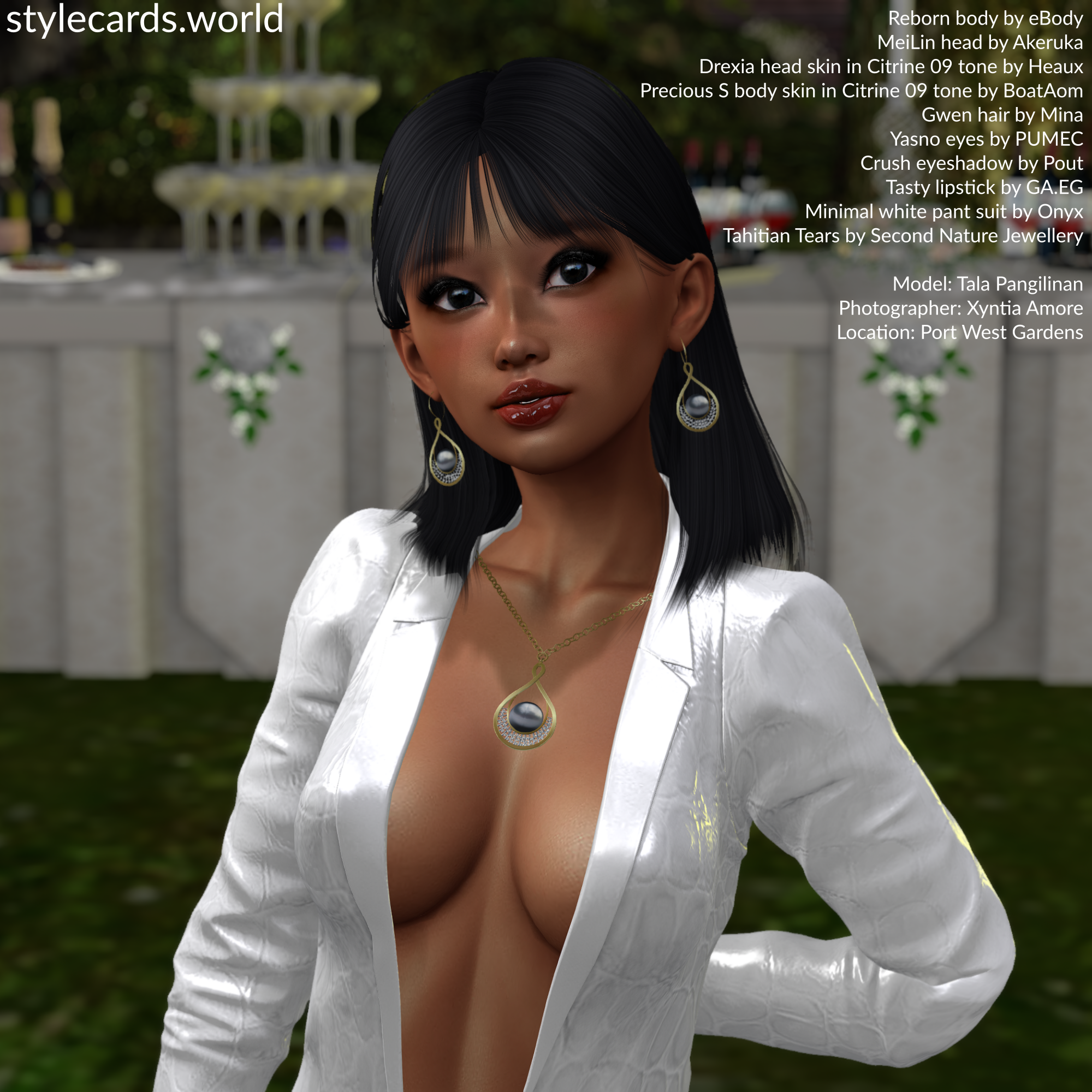 A closeup photo of Tala Pangilinan wearing a white leather suit at an outdoor wedding venue. She is wearing a jewelry set with a matching necklace and earrings, as well as glossy red lipstick and smoky eyeshadow.