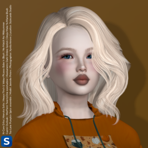 A headshot of Janneke Peters standing in front of a caramel-colored backdrop. She is wearing a festive orange hoodie with some pumpkin decorations on the front. She has long blonde hair, a hint of eyeshadow, some blush on her cheeks, and a brownish lipstick.