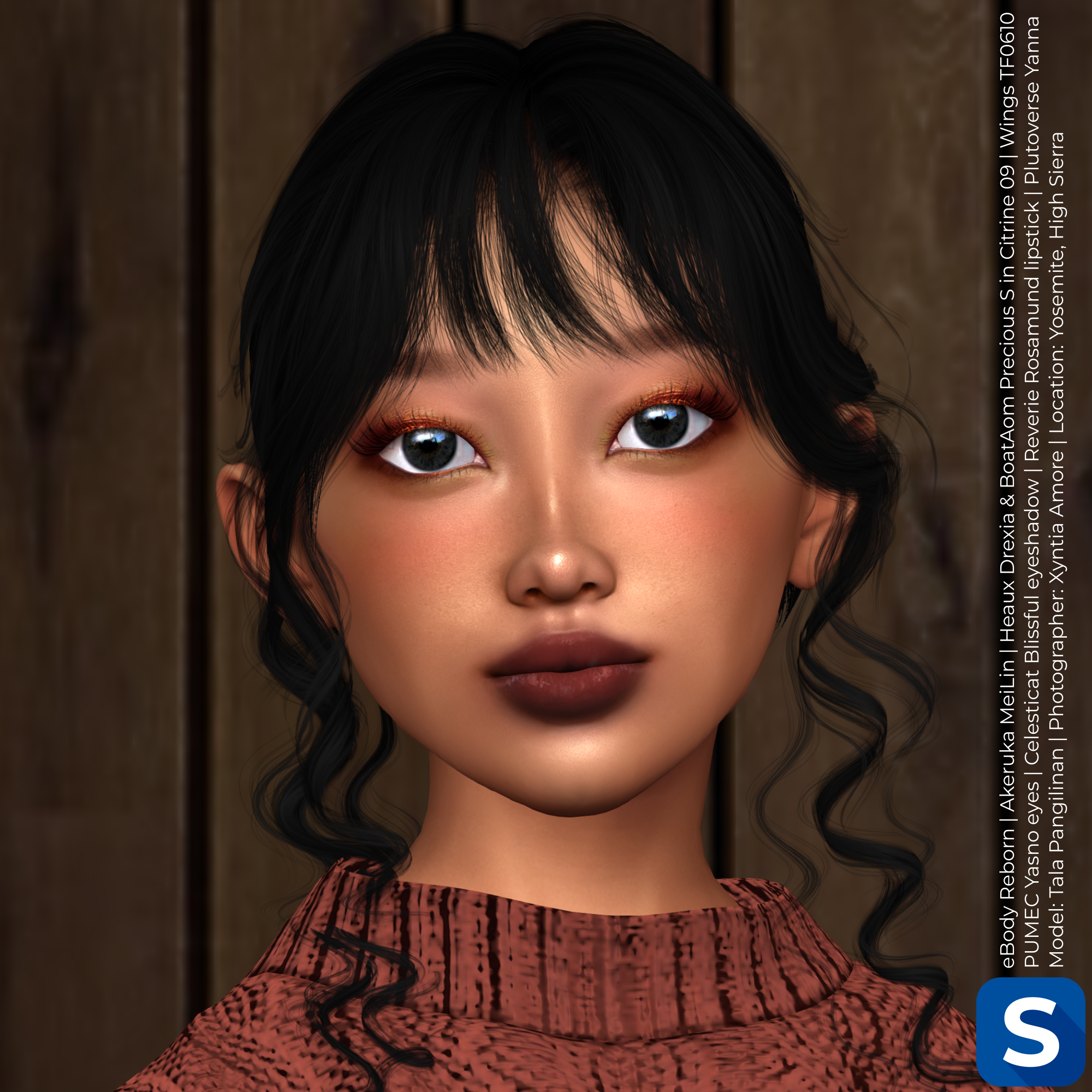 A headshot of Tala Pangilinan standing in front of a wood stained wall, while wearing a pumpkin-colored sweater. She has long black hair with long curls hanging from her temples. Her eyeshadow and lipstick are both subtle, yet dark.