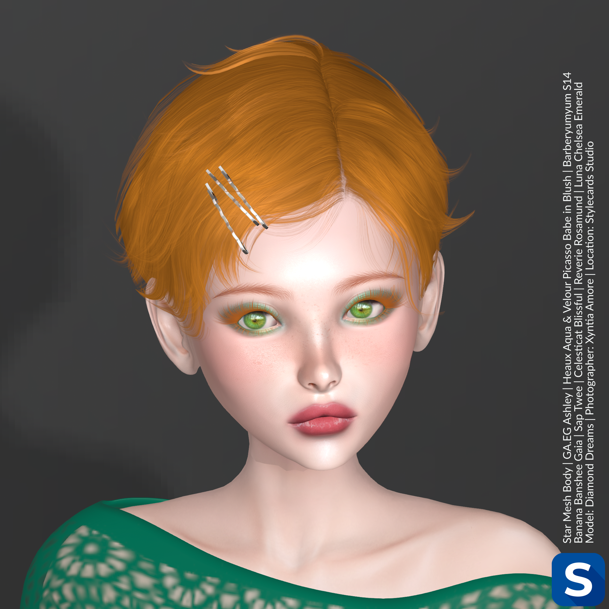 A headshot of Diamond Dreams has her posed in front of a dark grey backdrop. She has short red hair, is wearing some pink lipstick and green eyeshadow to match her green lace top from Luna Chelsea.