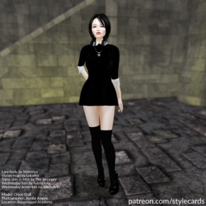 Chloe Doll stands in a black minidress accented by a white collar and white cuffs on the arms. For jewelry she has a necklace with a pentacle as a pendant. The ensemble is completed by black high-heels worn over black kneehighs.