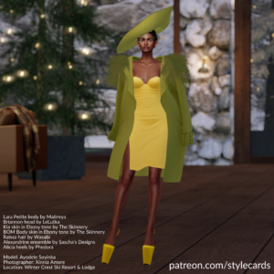 Ayodele Soyinka is standing in a winter lodge with pine trees and a snowy landscape in the background. She is wearing a yellow dress topped by a green jacket with fur trim and a matching green hat.