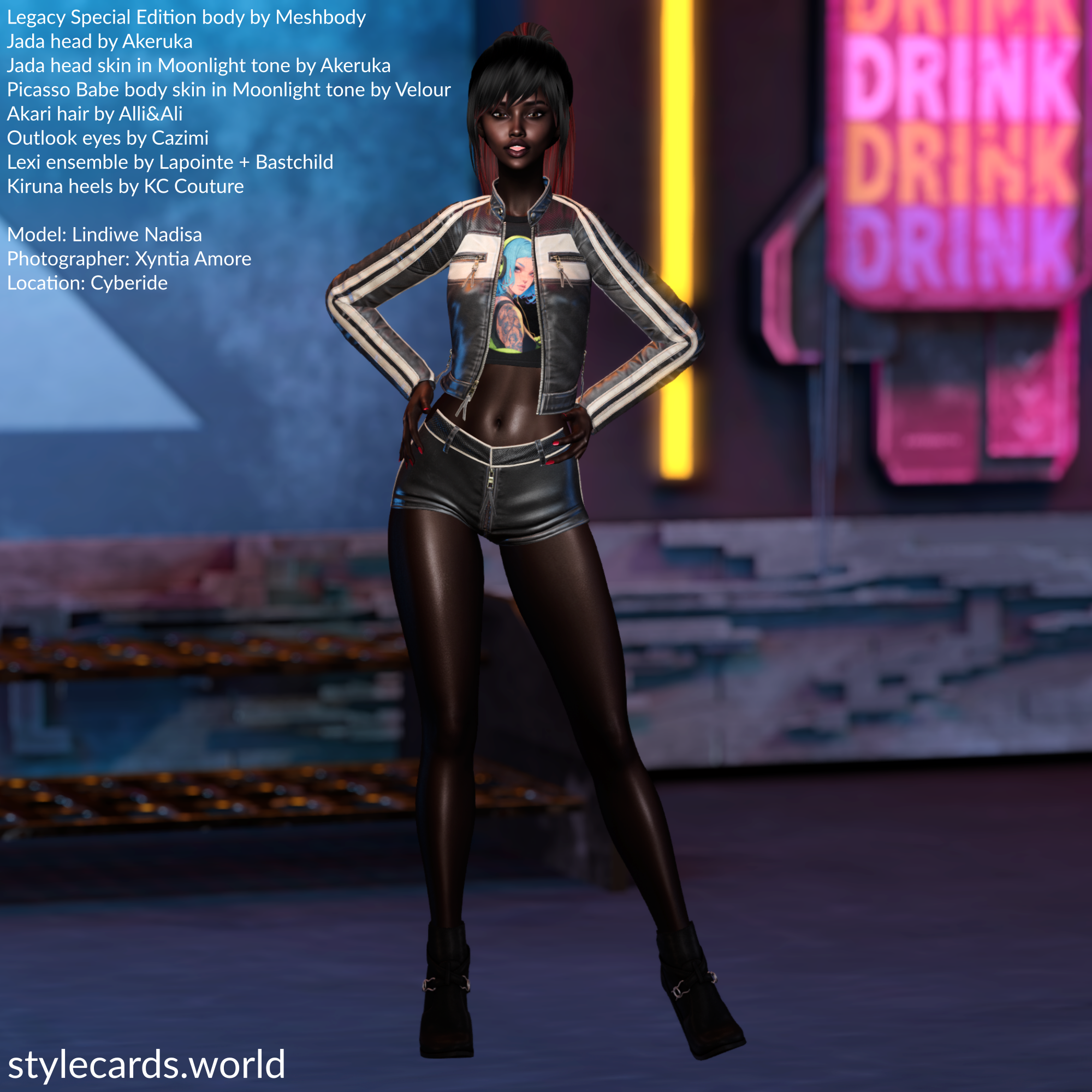 Lindiwe Nadisa is standing in front of some neon signs while wearing black leather shorts, a t-shirt, and a black leather jacket with white stripes running down the arms. She is standing with her hands on her hips and she is smiling for the camera.