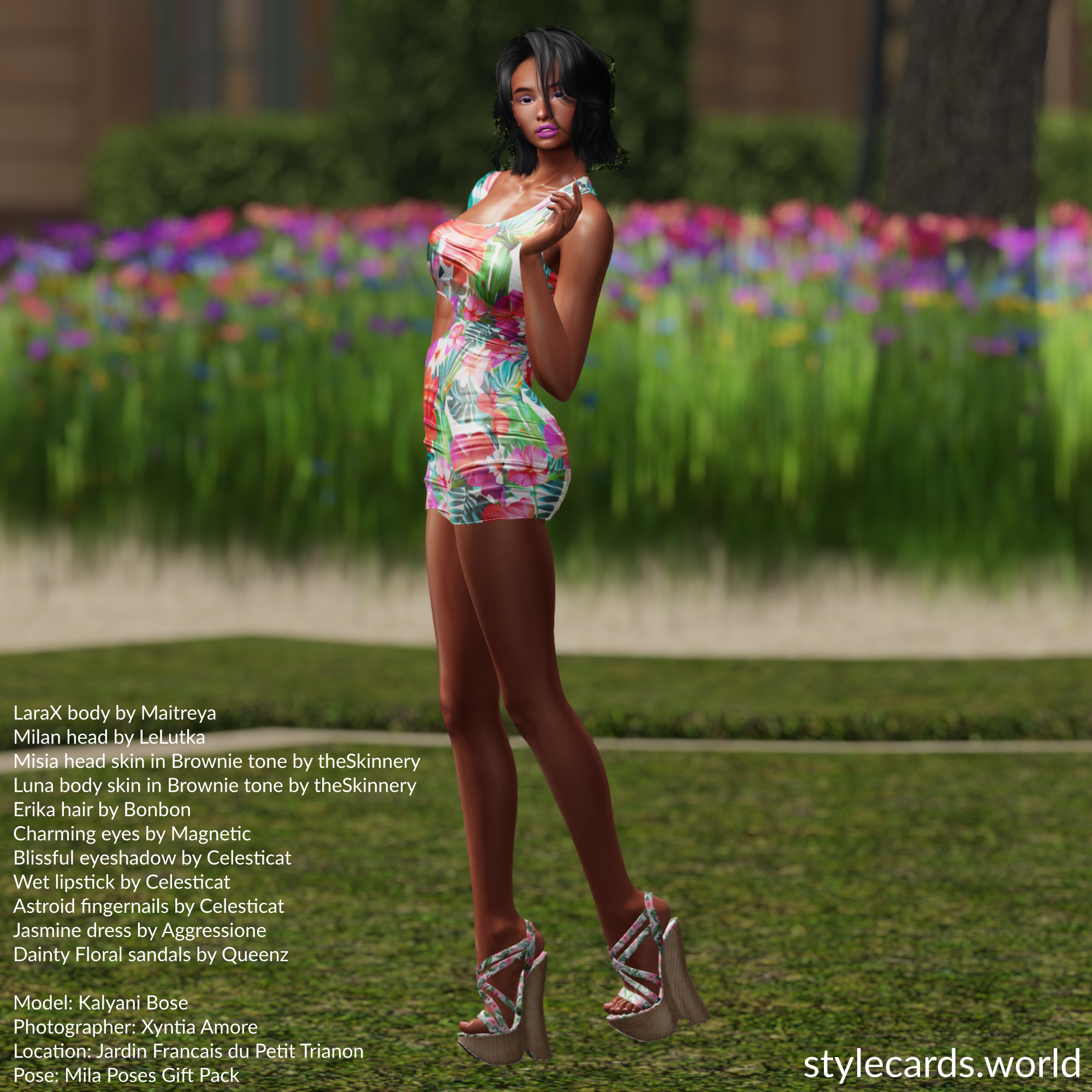 Kalyani Bose is posing in front a a bed of brightly colored flowers while wearing a minidress with a floral pattern that has similar colors as those of the garden. The straps of her high heels also have a colorful floral pattern.