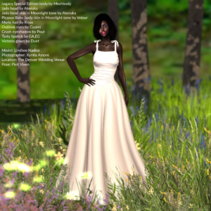 Model Lindiwe Nadisa is wearing an off-white wedding gown while standing in a meadow of wildflowers at The Denver Wedding Venue.