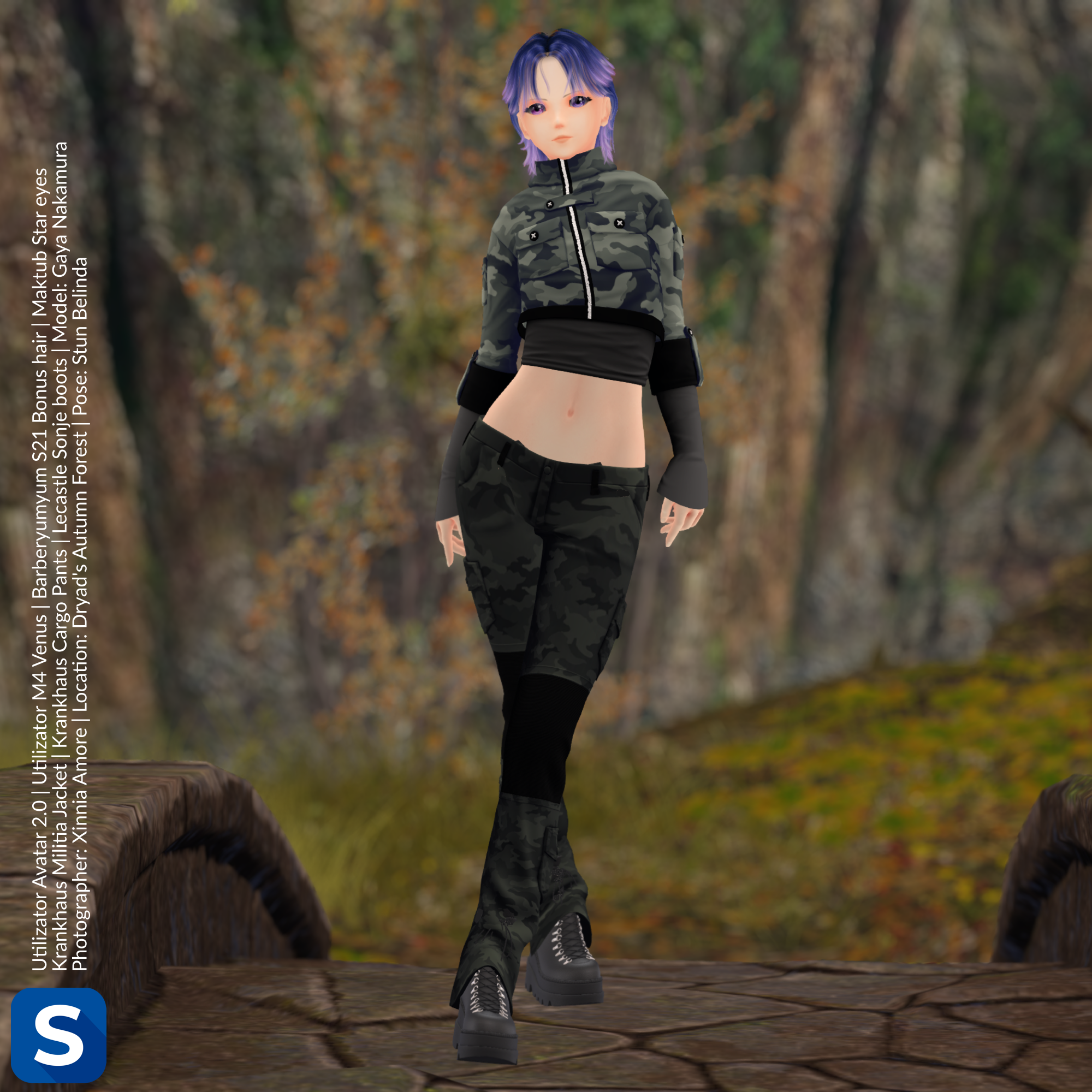 A photo of Gaya Nakamura standing on a stone bridge in a forest. She is wearing a camo jacket the exposes her midriff, along with a pair of camo pants, and black combat boots. Her hair is bluish-purple.
