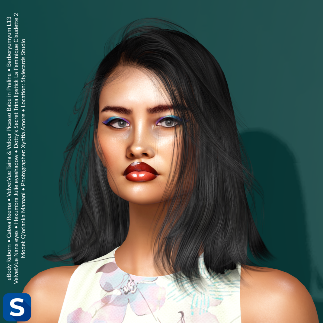 Makeup Monday, August 10, 2026 A headshot of a model standing in front of a dark teal backdrop. Her long black hair is hanging over her sleeveless floral-patterned top. Her lips are adorned with glossy red lipstick from Dotty's Secret, while her upper eyelids have been bedighted with blue-and-purple eyeshadow and black eyeliner.