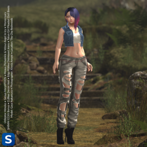 A denim-clad model stands on a dirt trail in a forest. She's wearing black high heel ankle boots, grey denim jeans with many fashionable holes, a pink chain belt with heart-shaped links, a white crop t-shirt and a blue denim vest. Her asymmetric hair style is ombre blue and purple.