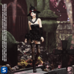 A darkly lit photo of a woman standing among tombstones in an old graveyard. With her apparel all in black, she is wearing a witch's hat, a mini dress with matching gauntlets, mesh and lace stocking, calf-high boots, and a lace shawl.
